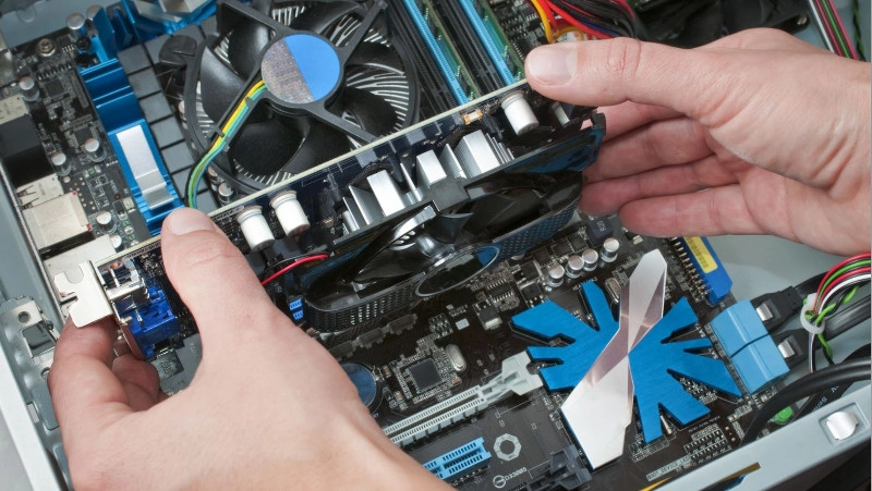 pc repair technician removing graphics card