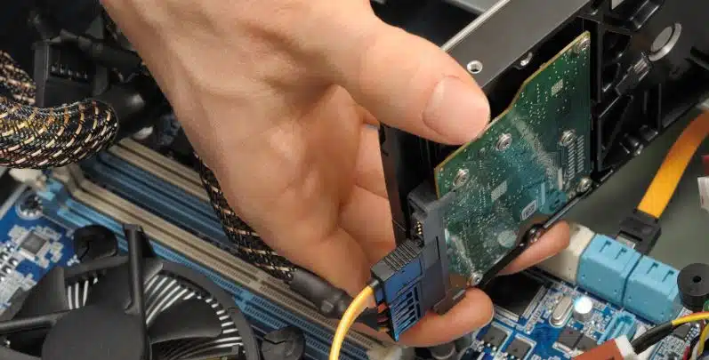 computer mechanic installing hard drive