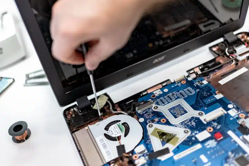 Technician disassembling a laptop 