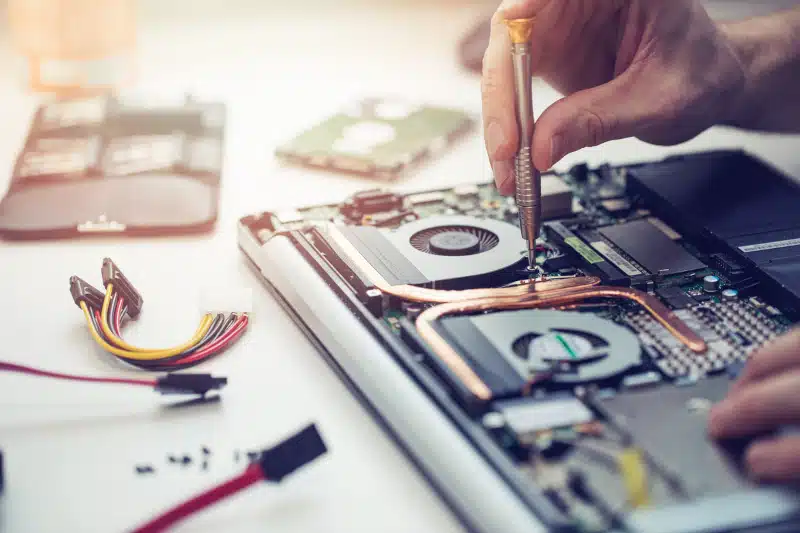 technician repairing laptop computer closeup.